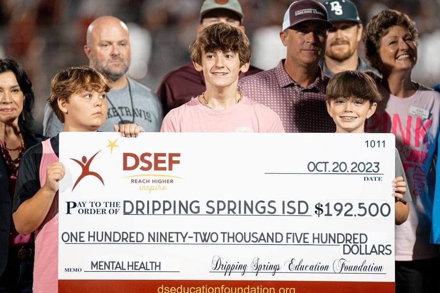 kids holding up giant check for DSEF