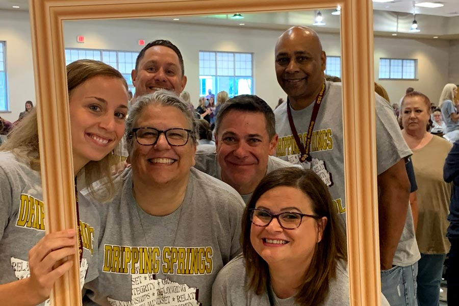 members of DSEF holding up picture frame and posing for photo