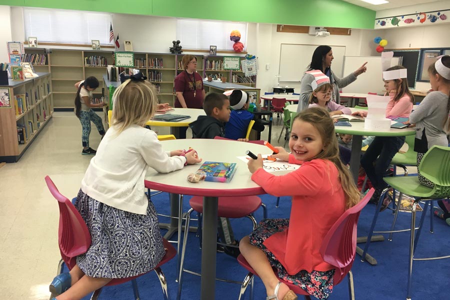 children sitting at tables in library for Kinder Club